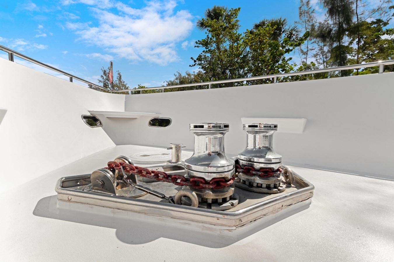 a white car with a red and black engine on a white surface aboard MAC Yacht for Sale