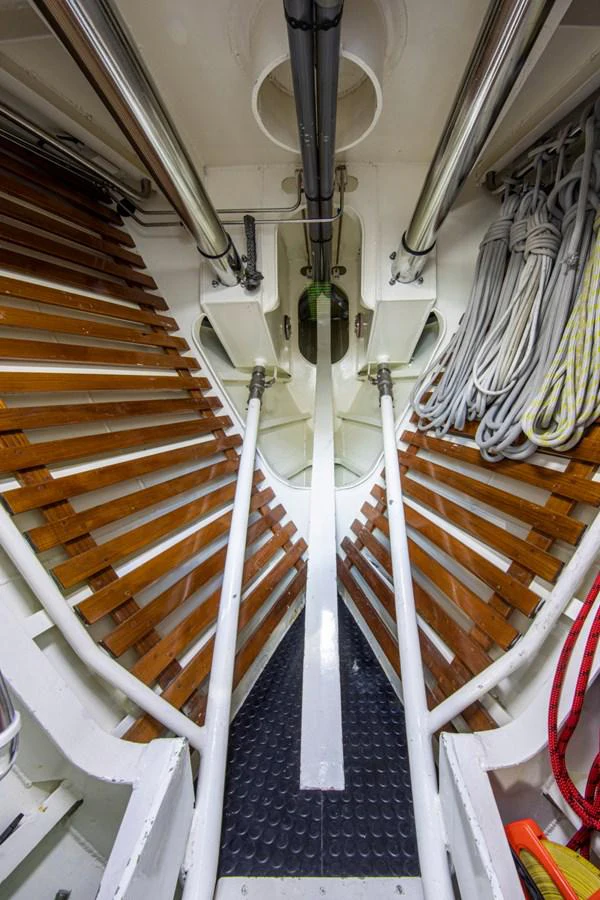a staircase with a chandelier aboard LEGEND Yacht for Sale