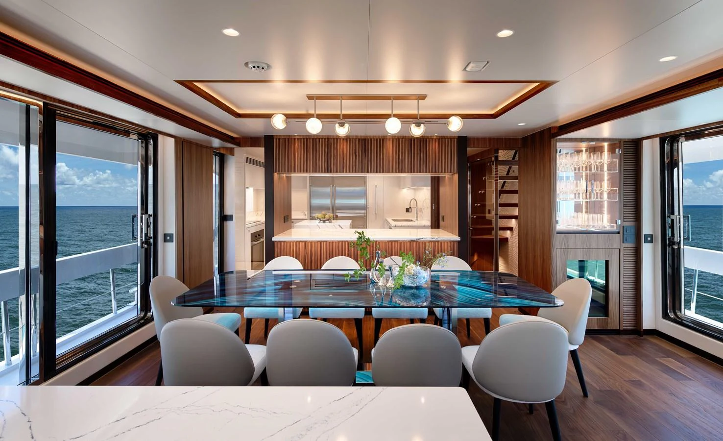 a large room with a table and chairs aboard HORIZON FD100/911 Yacht for Sale