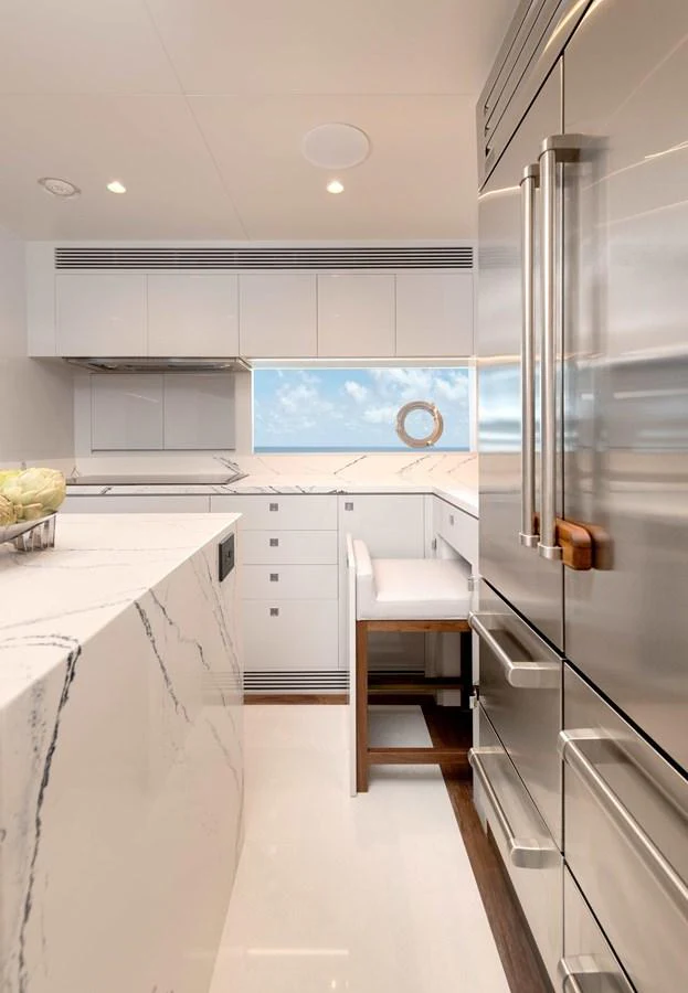 a kitchen with white cabinets aboard HORIZON FD100/911 Yacht for Sale
