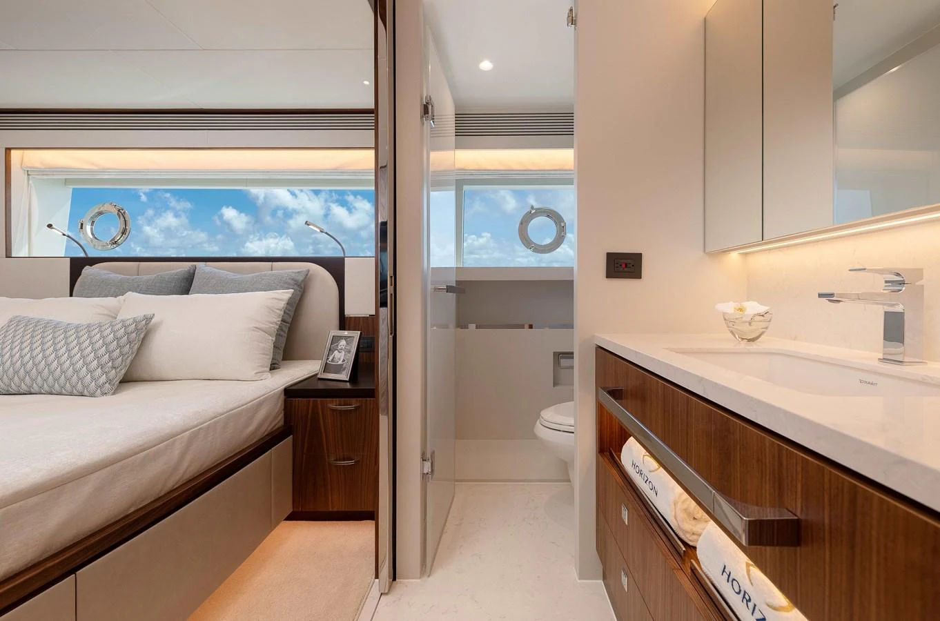 a bedroom with a bed and a sink aboard HORIZON FD100/911 Yacht for Sale