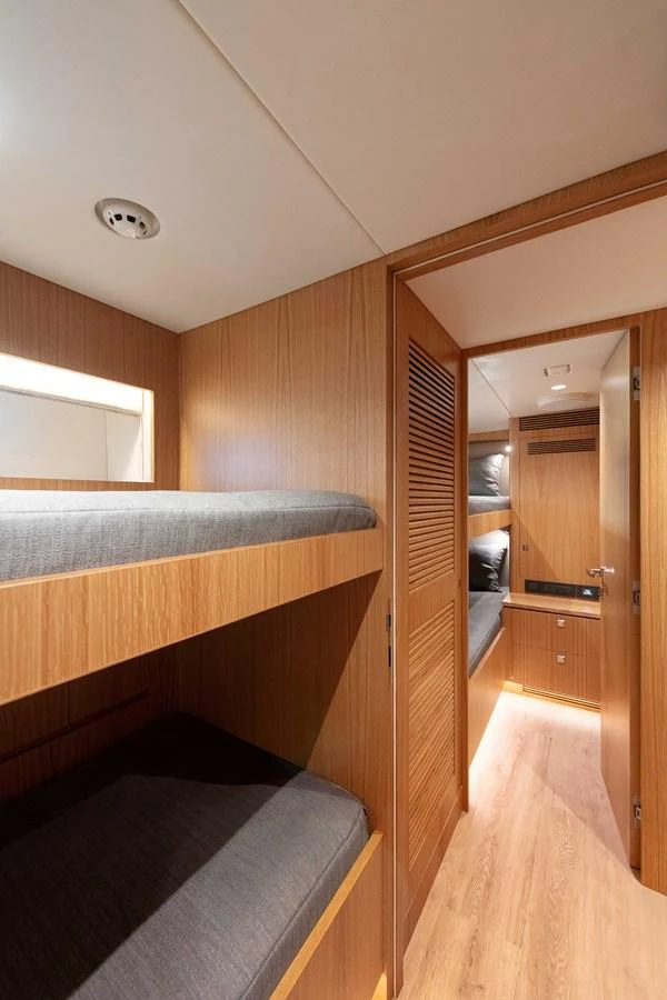 a room with a bed and a wood door aboard HORIZON FD100/911 Yacht for Sale