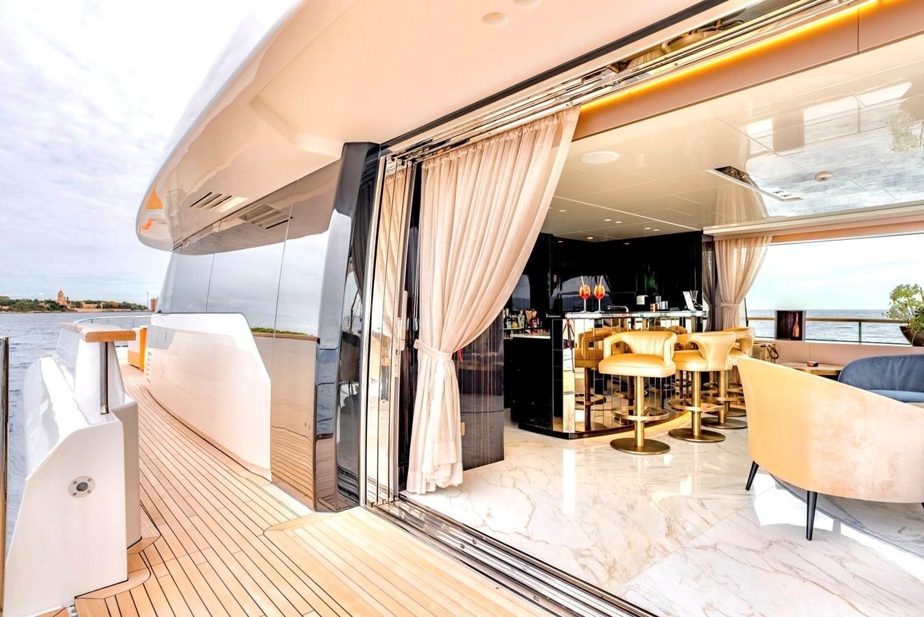 a room with a large window and a table with chairs and a large window aboard INS LAND Yacht for Sale