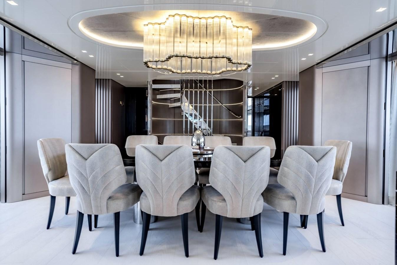 a room with a chandelier and chairs aboard INS LAND Yacht for Sale