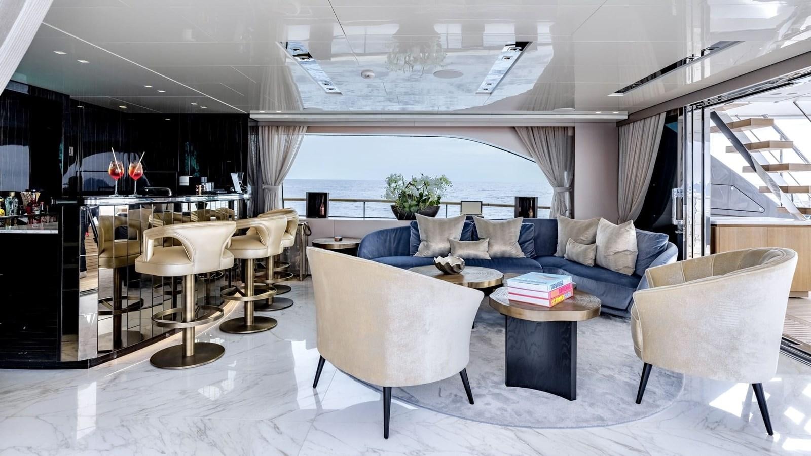 a living room with a couch and a table aboard INS LAND Yacht for Sale