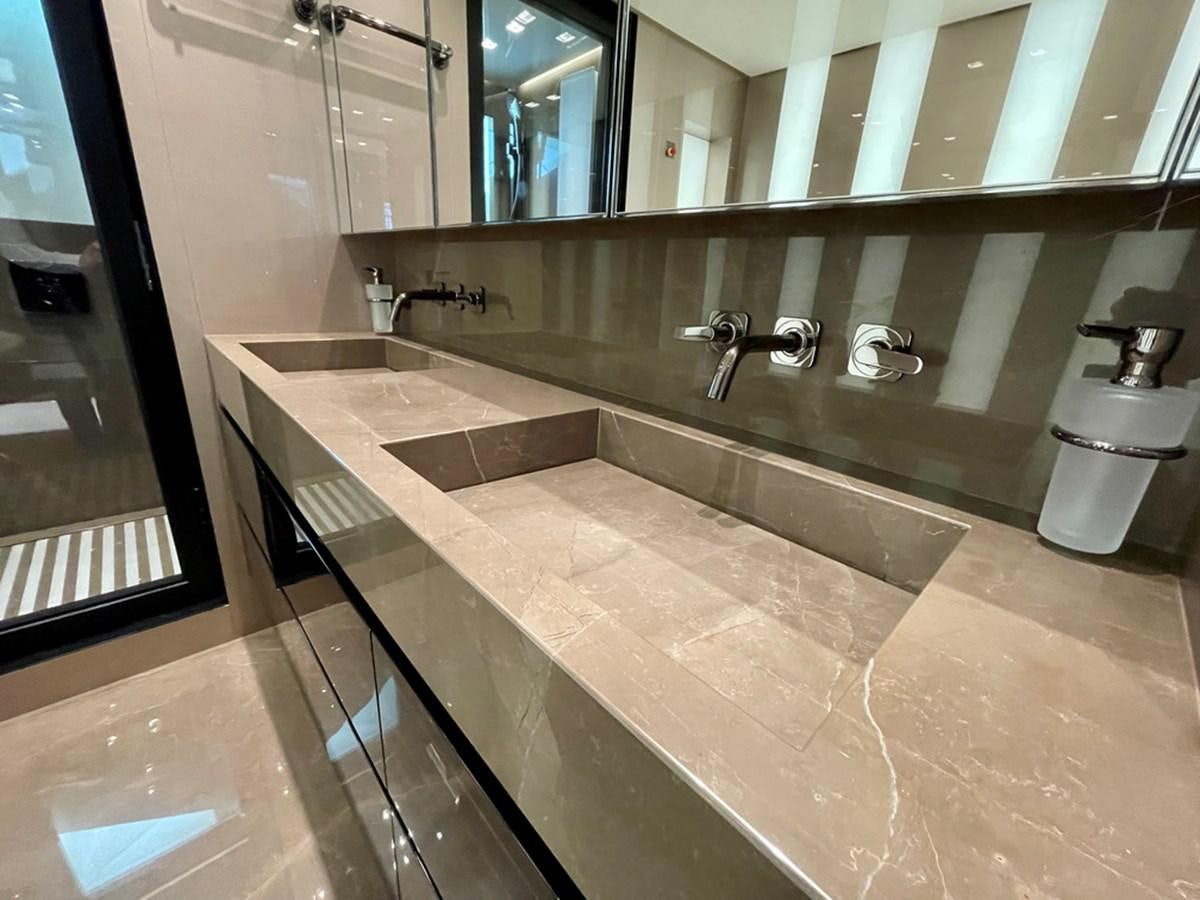 a bathroom with a large marble counter aboard INS LAND Yacht for Sale