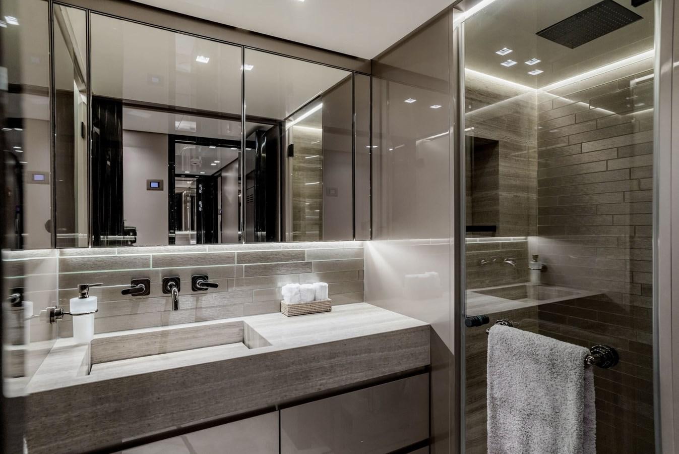 a bathroom with a large mirror aboard INS LAND Yacht for Sale