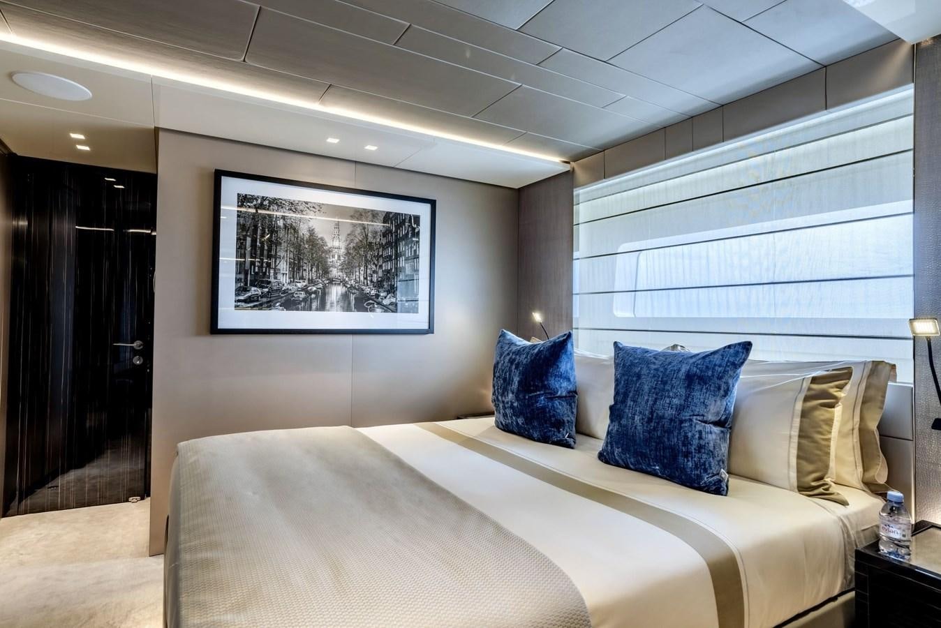 a bed with a white bed spread aboard INS LAND Yacht for Sale