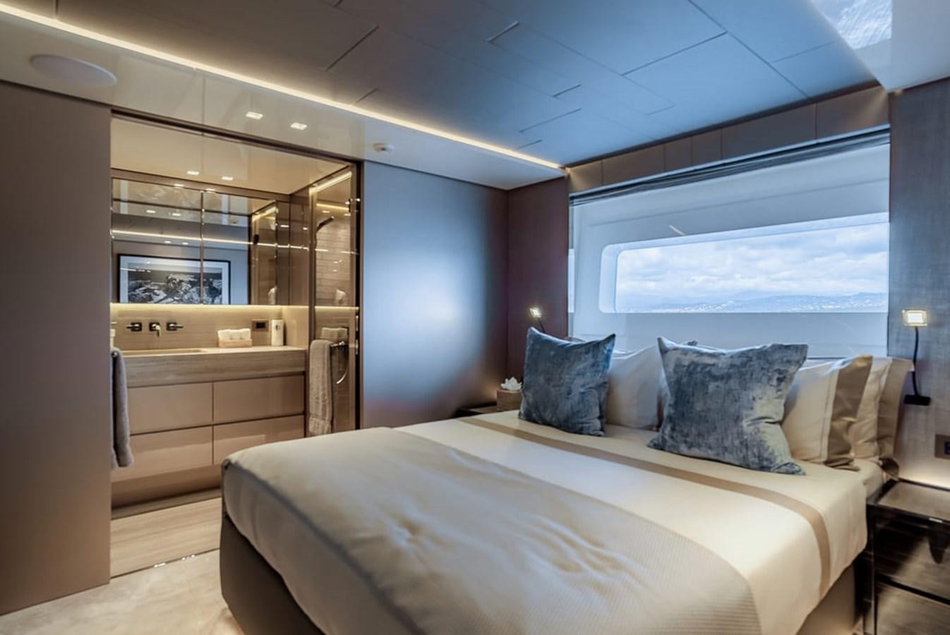 a large bedroom with a large bed aboard INS LAND Yacht for Sale
