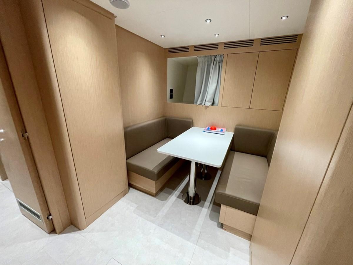 a room with a table and chairs aboard INS LAND Yacht for Sale