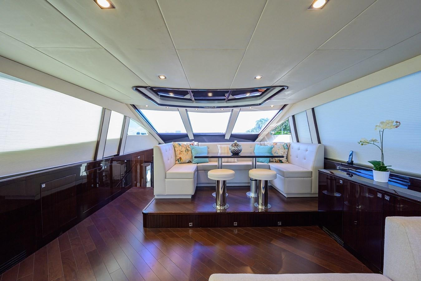 a room with a wood floor and a couch and a table with chairs aboard ALGORYTHM Yacht for Sale
