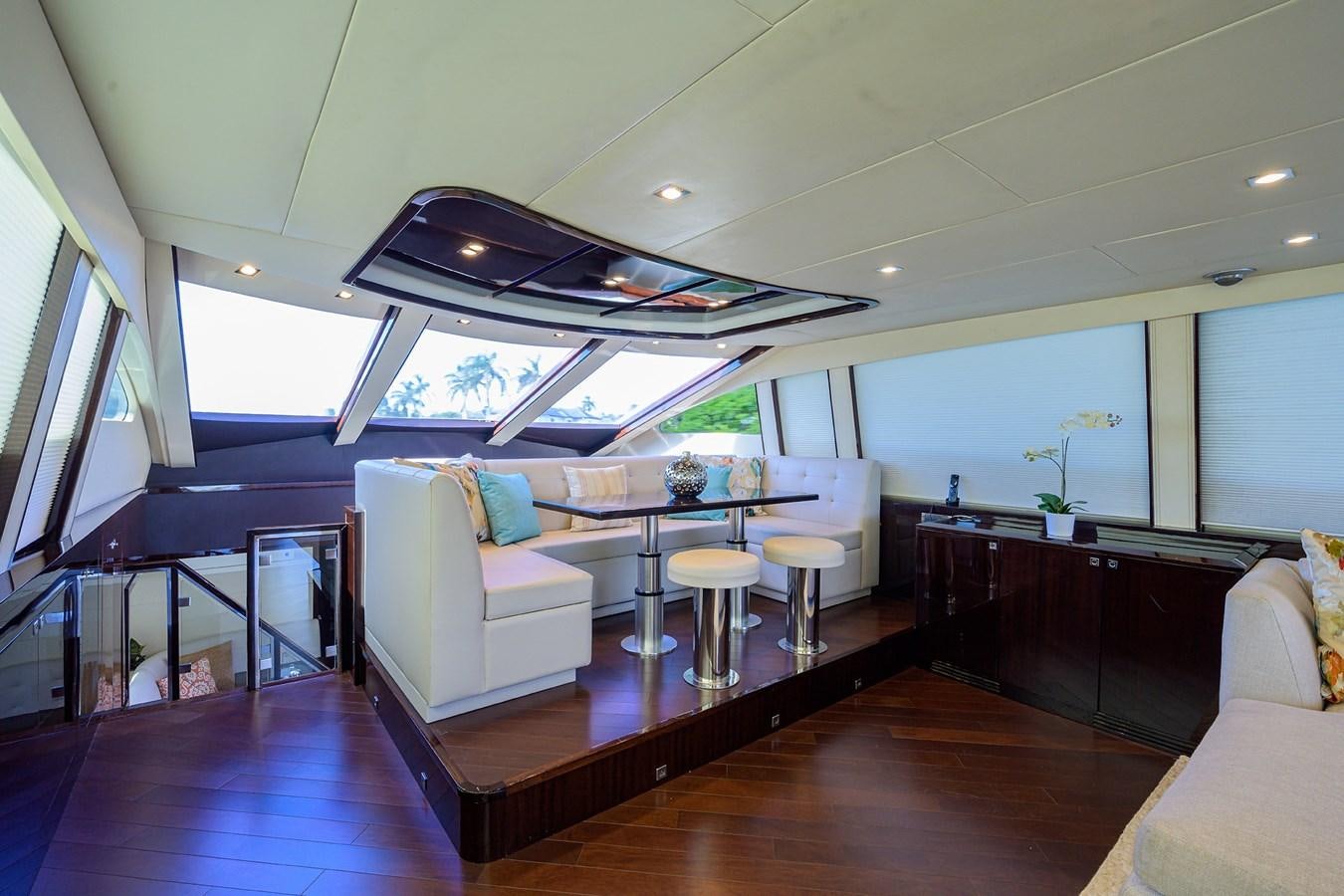 a room with a table chairs and a couch aboard ALGORYTHM Yacht for Sale