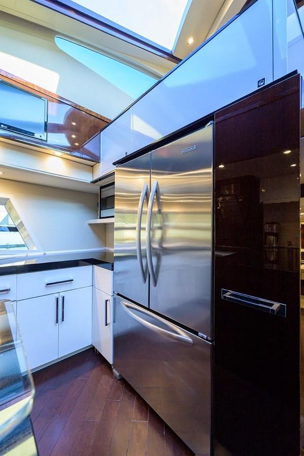 a kitchen with a stainless steel refrigerator aboard ALGORYTHM Yacht for Sale