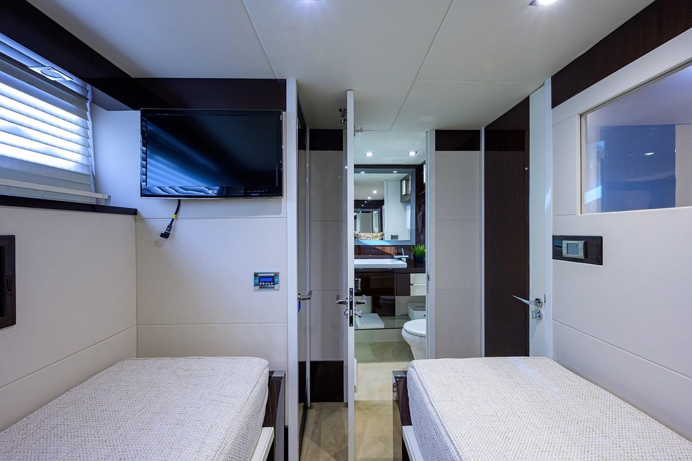 a room with a bed and a tv on the wall aboard ALGORYTHM Yacht for Sale