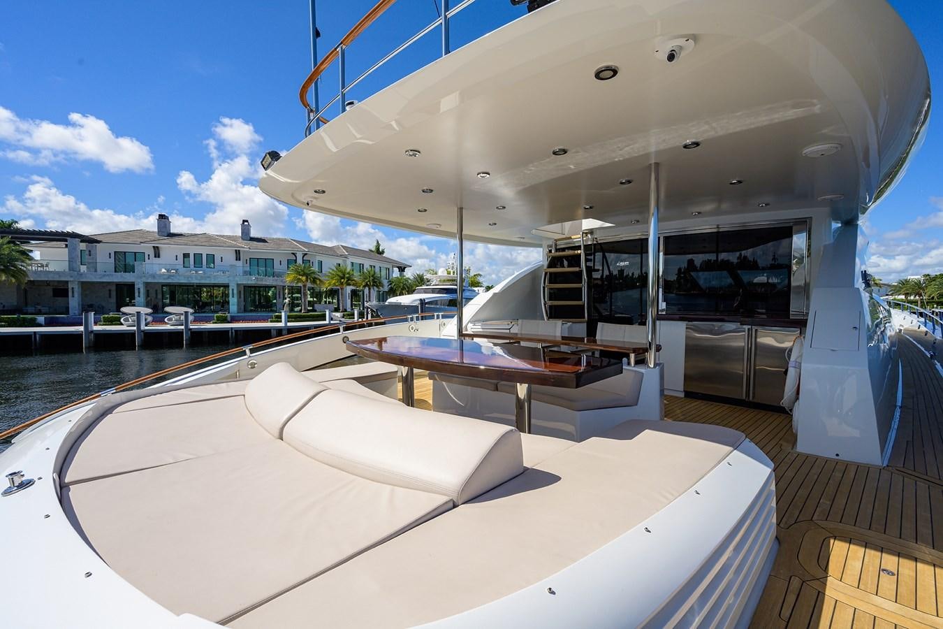a pool with a table and a bench on the deck aboard ALGORYTHM Yacht for Sale
