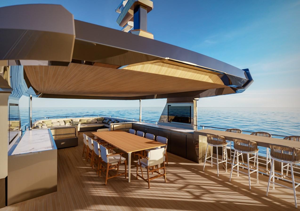 a deck with a table and chairs on it aboard PICCOLO Yacht for Sale