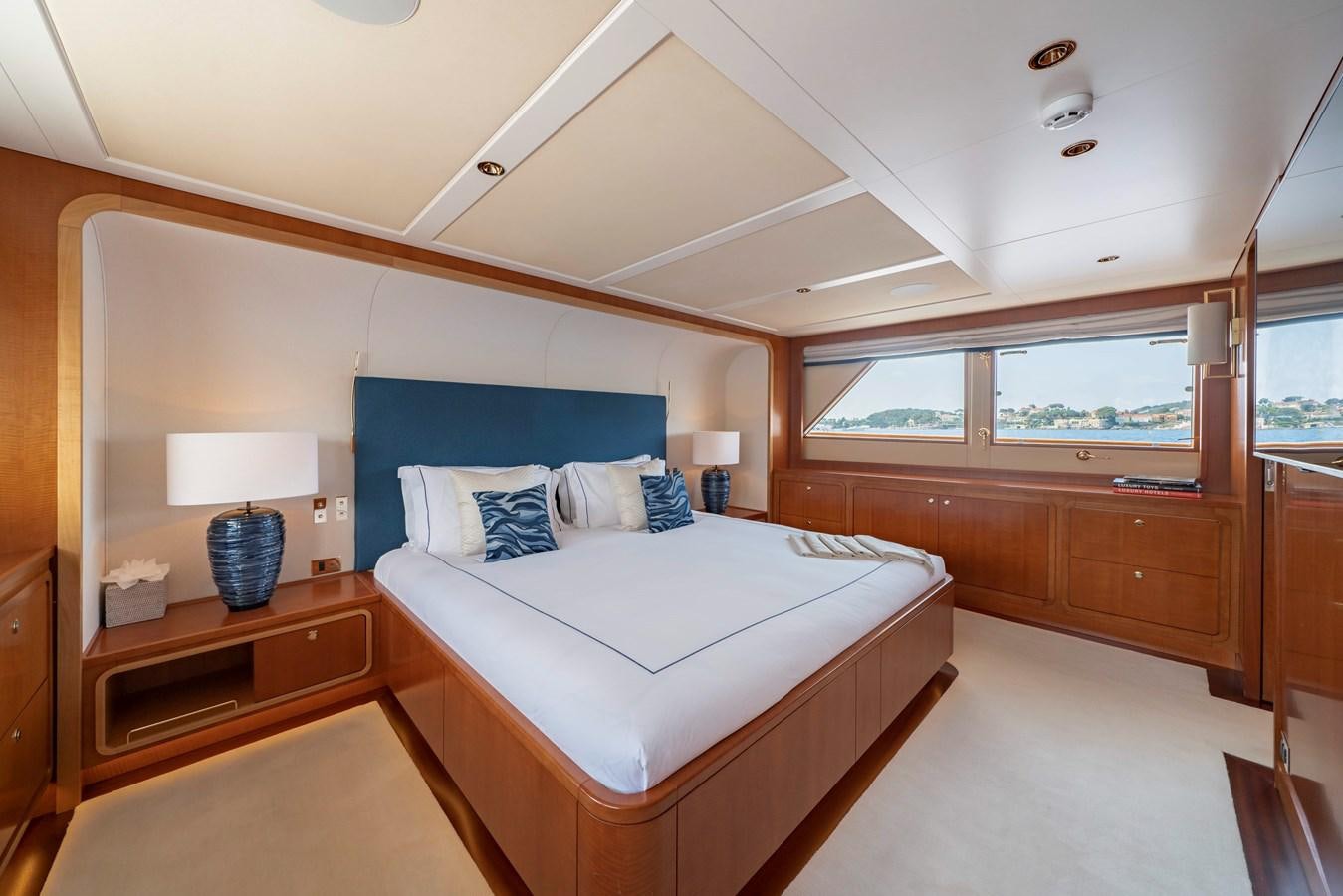 a bedroom with a bed and a desk aboard SYNTHESIS 66 Yacht for Sale