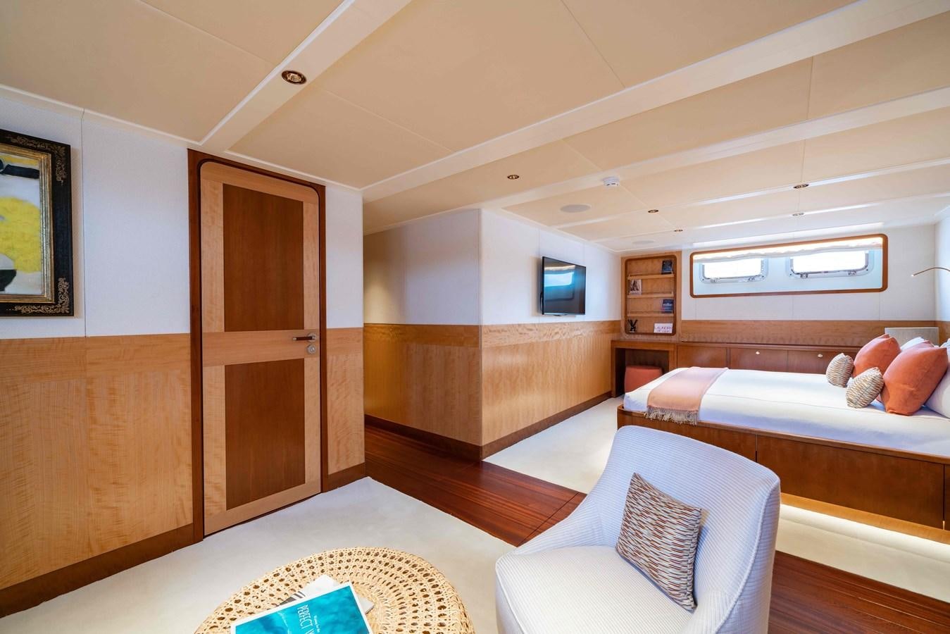 a bedroom with a bed and a couch aboard SYNTHESIS 66 Yacht for Sale