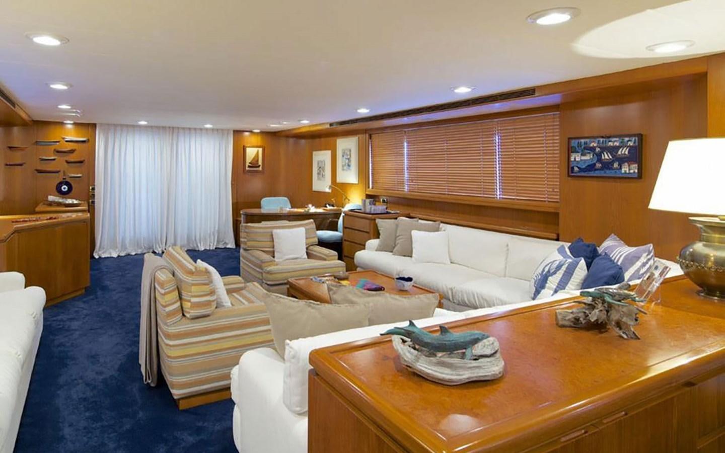 a living room with a couch and a table aboard JUNESTAR Yacht for Sale