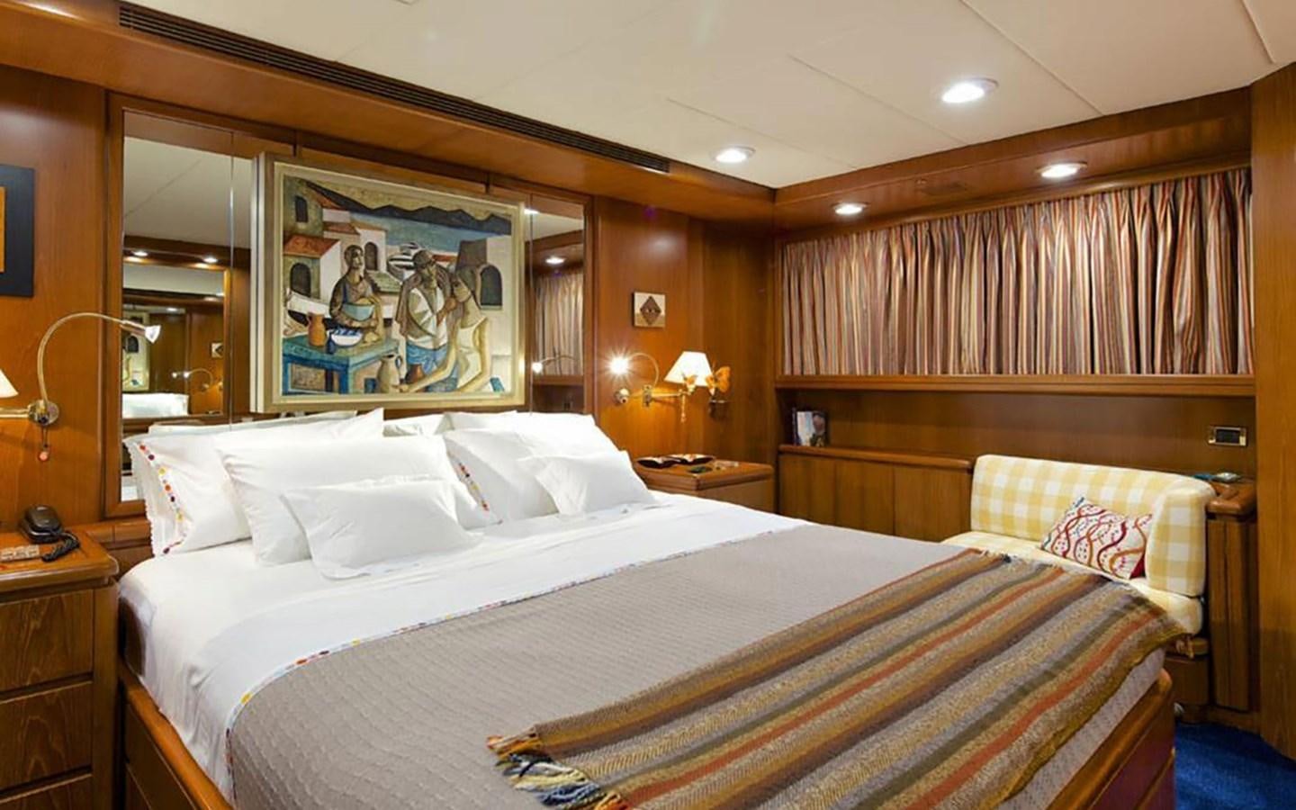 a room with a bed and a mirror aboard JUNESTAR Yacht for Sale