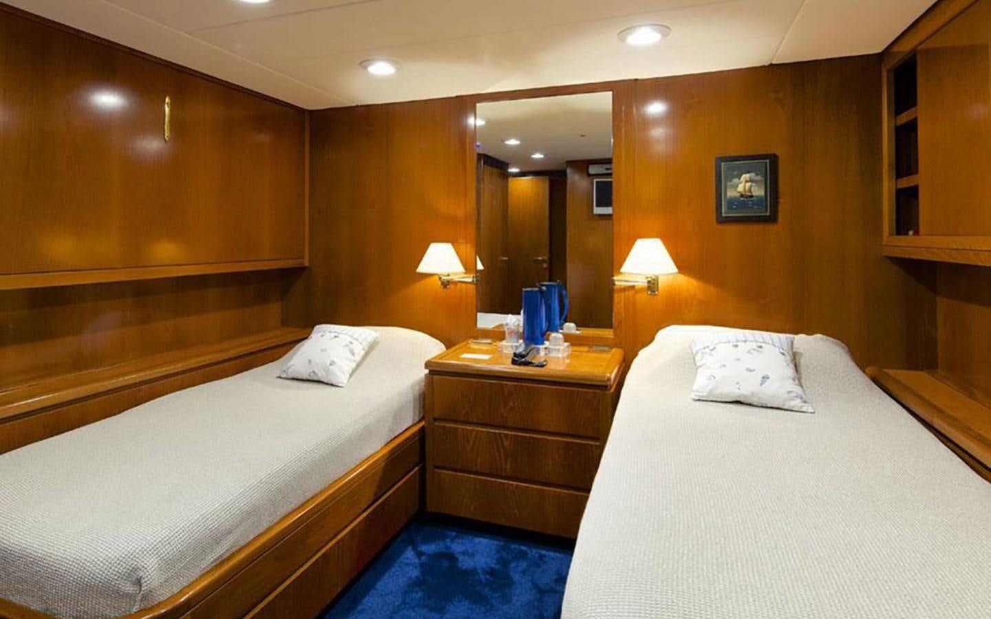 a couple of beds in a hotel room aboard JUNESTAR Yacht for Sale