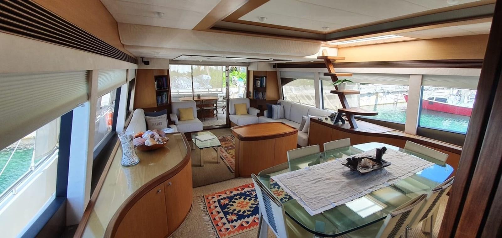 a living room with a large window aboard SEDROP - 2006 FERRETTI 731 @ PTO. AVENTURAS Yacht for Sale