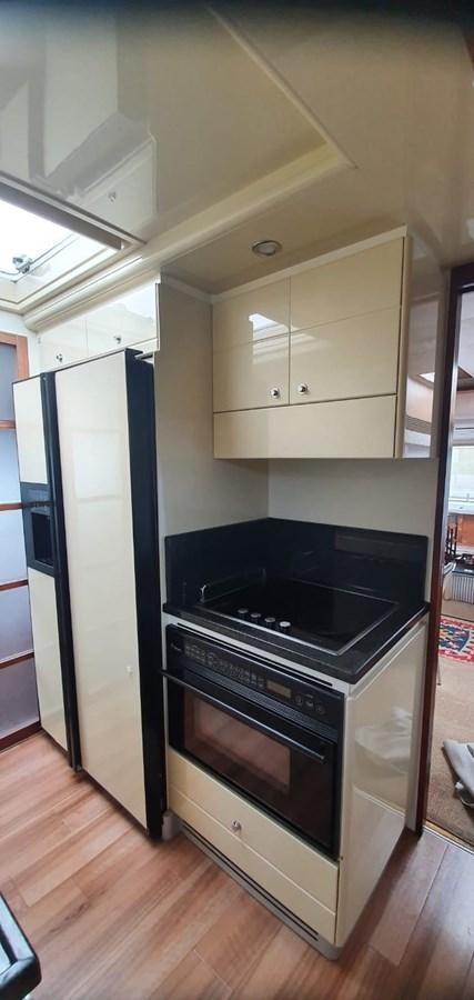 a stove and cabinets in a kitchen aboard SEDROP - 2006 FERRETTI 731 @ PTO. AVENTURAS Yacht for Sale