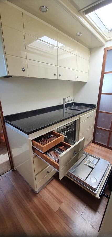 a kitchen with a stove and cabinets aboard SEDROP - 2006 FERRETTI 731 @ PTO. AVENTURAS Yacht for Sale