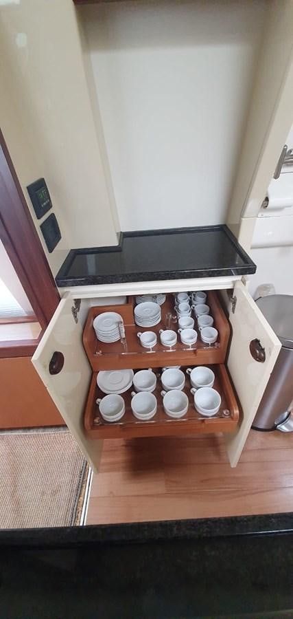 a shelf with cups on it aboard SEDROP - 2006 FERRETTI 731 @ PTO. AVENTURAS Yacht for Sale