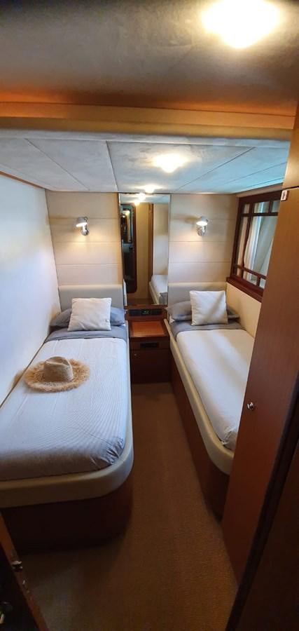 a room with a bed and a mirror aboard SEDROP - 2006 FERRETTI 731 @ PTO. AVENTURAS Yacht for Sale