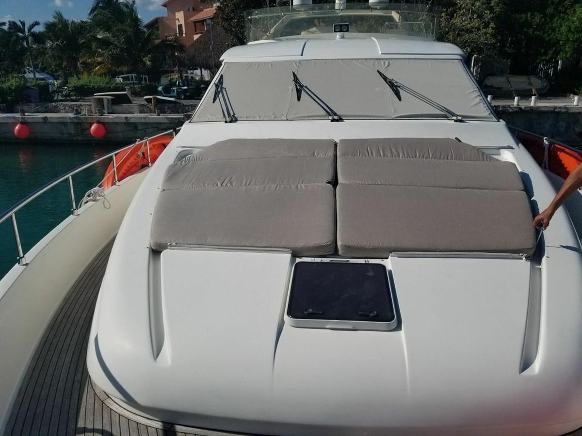a white boat on a dock aboard SEDROP - 2006 FERRETTI 731 @ PTO. AVENTURAS Yacht for Sale