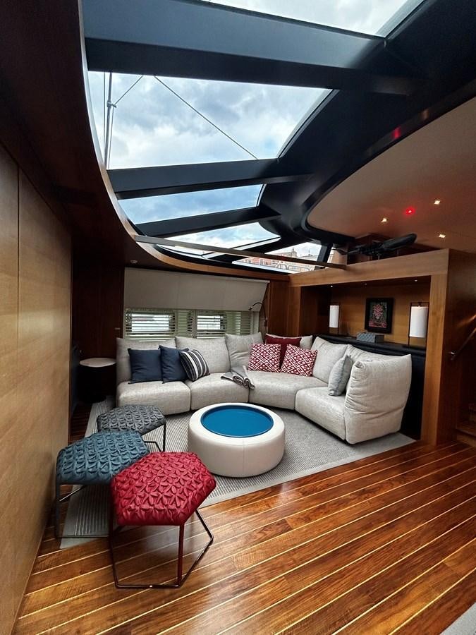 a living room with a large window aboard STATE OF GRACE Yacht for Charter