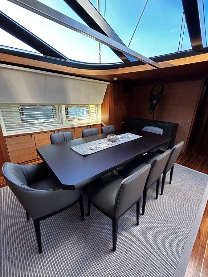 a room with a table and chairs aboard STATE OF GRACE Yacht for Charter