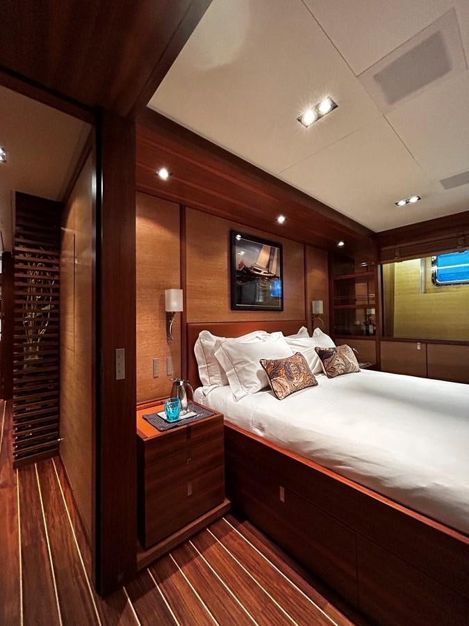 a bedroom with a bed and a mirror aboard STATE OF GRACE Yacht for Charter