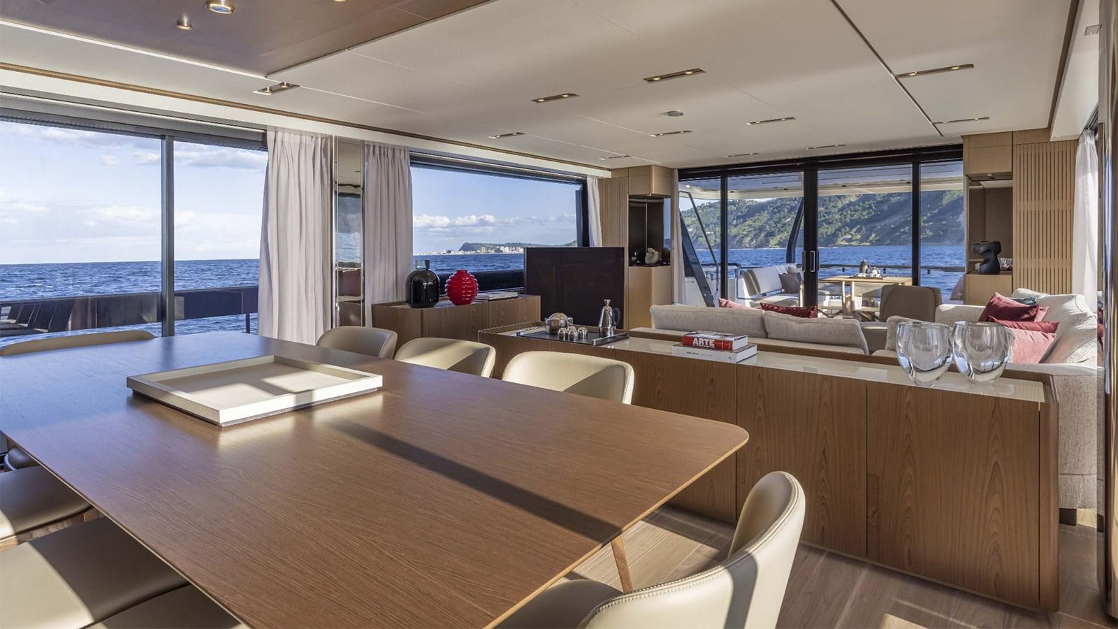 a room with a table and chairs aboard FERRETTI 1000 Yacht for Sale