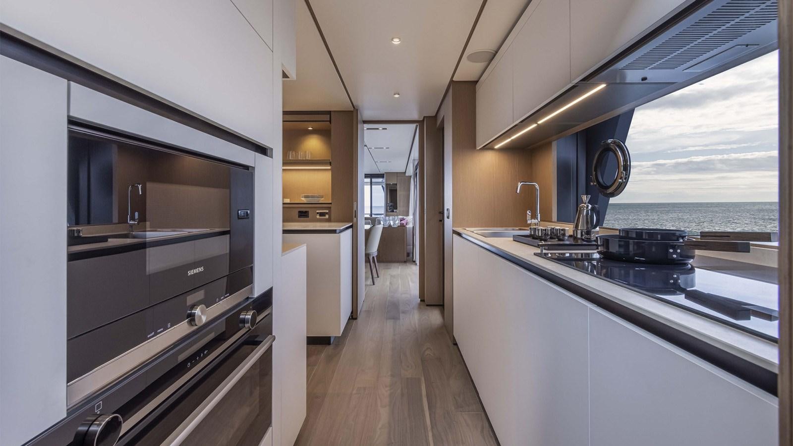 a kitchen with a large window aboard FERRETTI 1000 Yacht for Sale