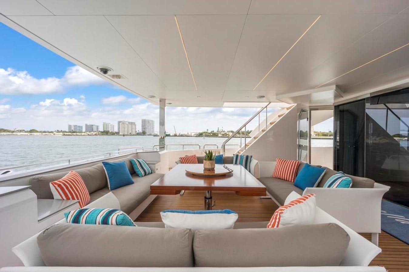 a living room with a large balcony aboard BELLA TU Yacht for Sale