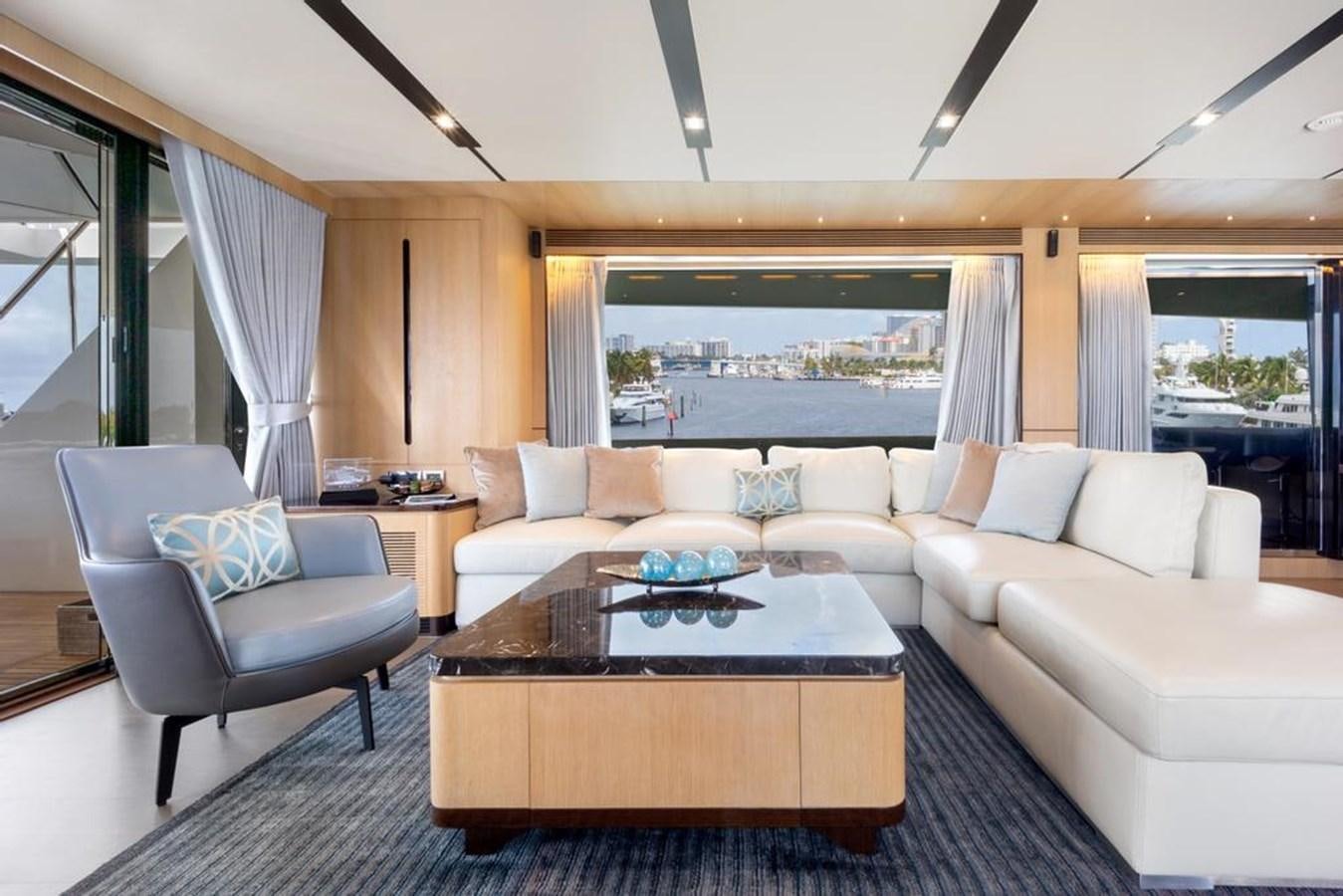 a living room with a couch and a table aboard BELLA TU Yacht for Sale