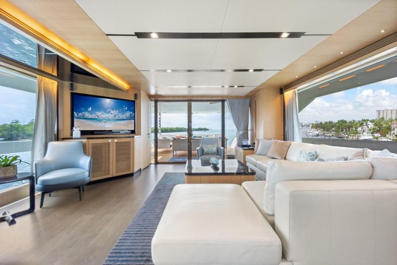 a living room with a large screen aboard BELLA TU Yacht for Sale