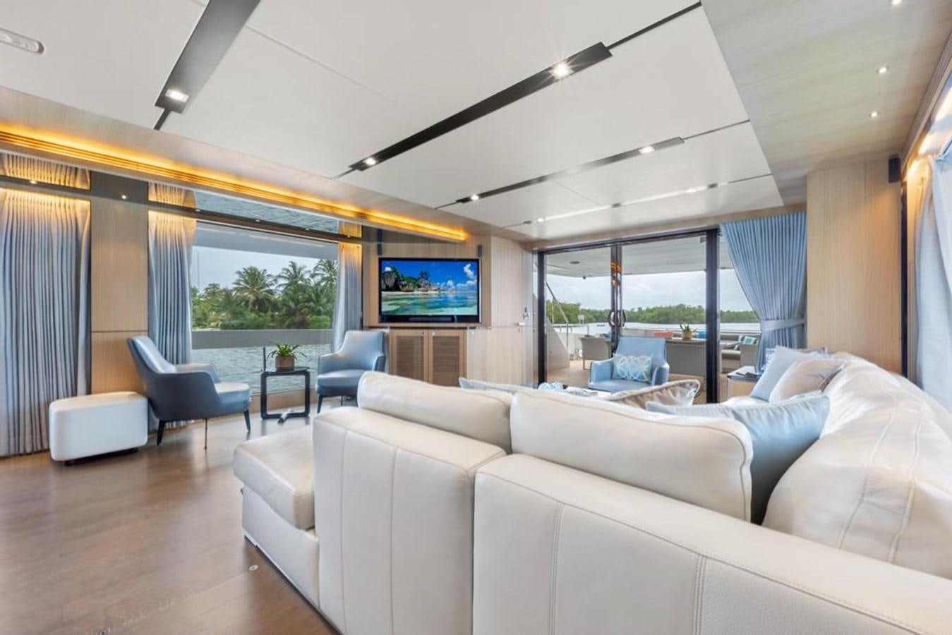 a living room with a large screen aboard BELLA TU Yacht for Sale