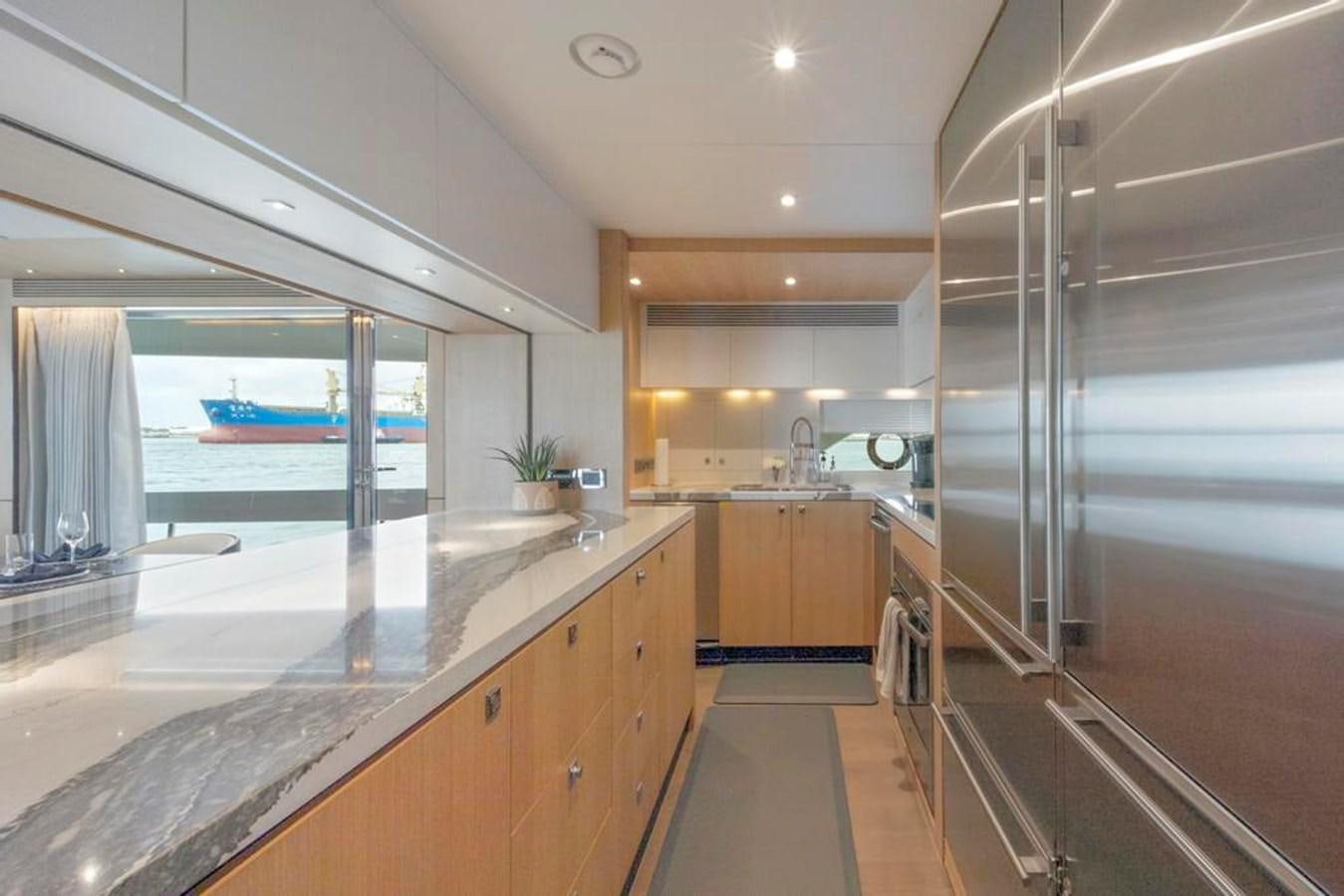 a large kitchen with a large glass shower aboard BELLA TU Yacht for Sale