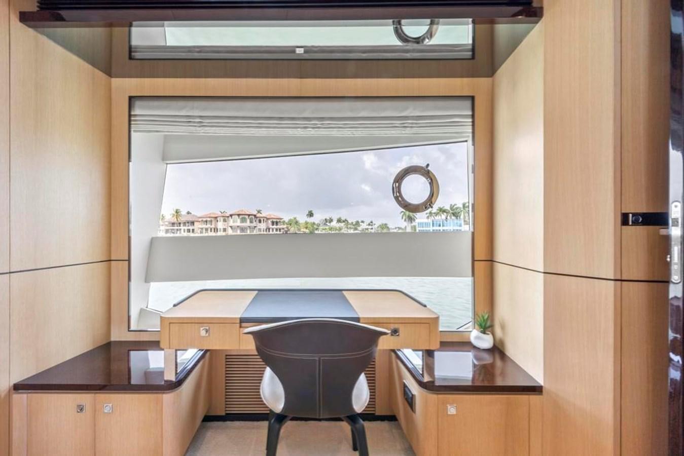 a room with a desk and a large screen aboard BELLA TU Yacht for Sale
