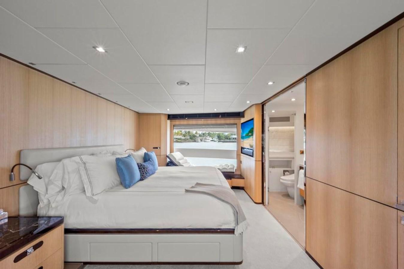 a bedroom with a bed and a closet aboard BELLA TU Yacht for Sale