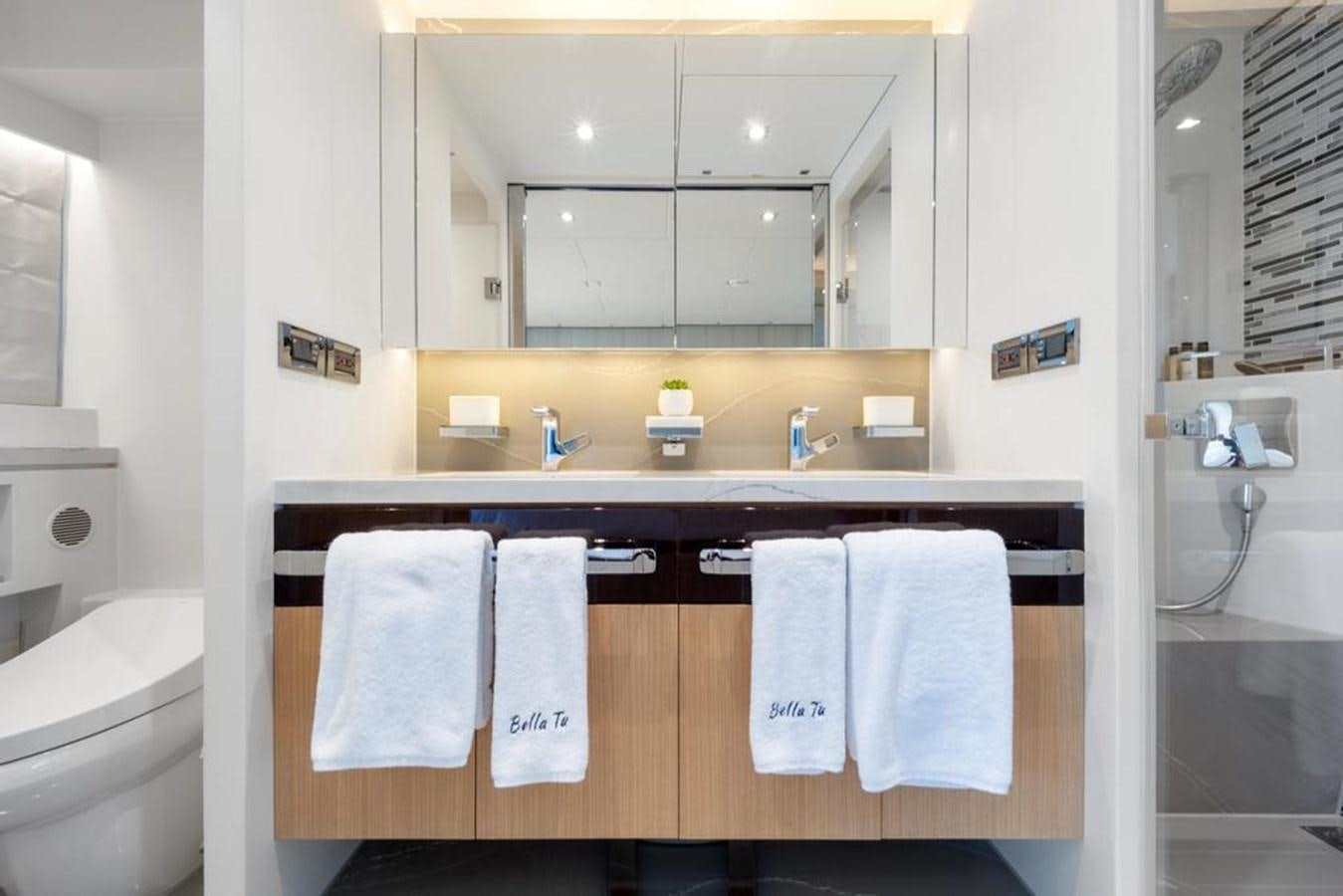 a bathroom with a mirror and towels aboard BELLA TU Yacht for Sale