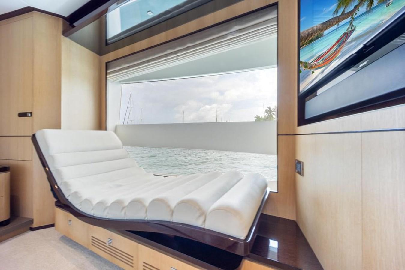 a room with a bed and a window aboard BELLA TU Yacht for Sale