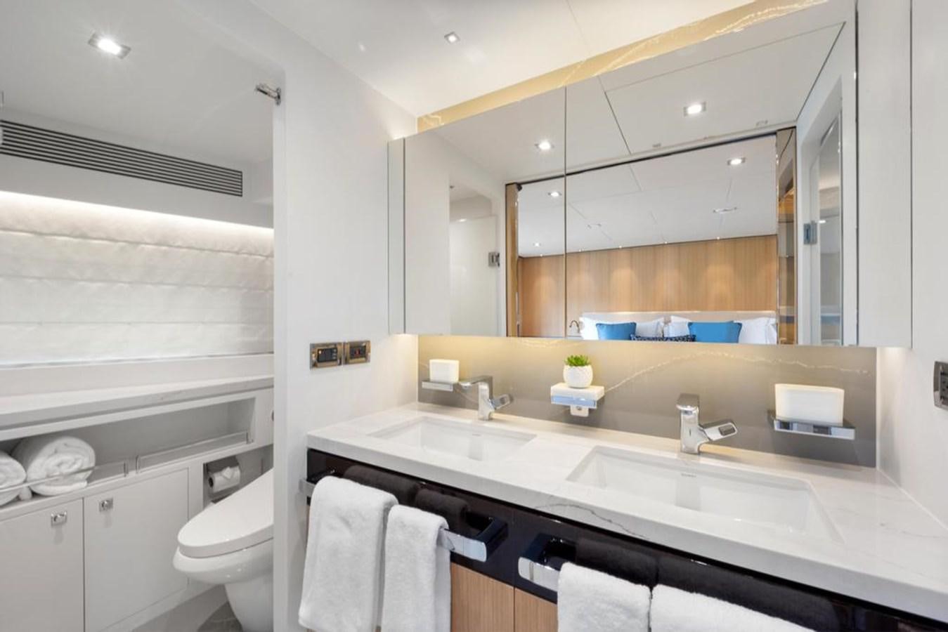 a bathroom with a sink and a mirror aboard BELLA TU Yacht for Sale