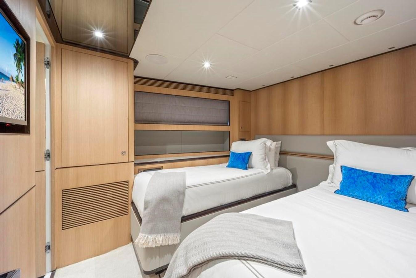 a room with a bed and a chair aboard BELLA TU Yacht for Sale