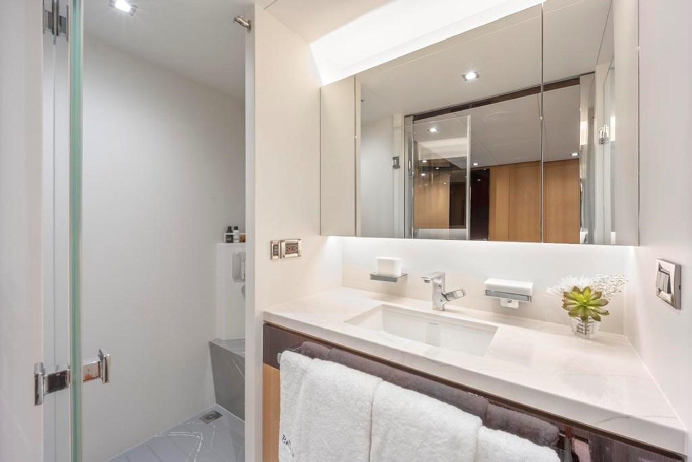 a bathroom with a large mirror aboard BELLA TU Yacht for Sale