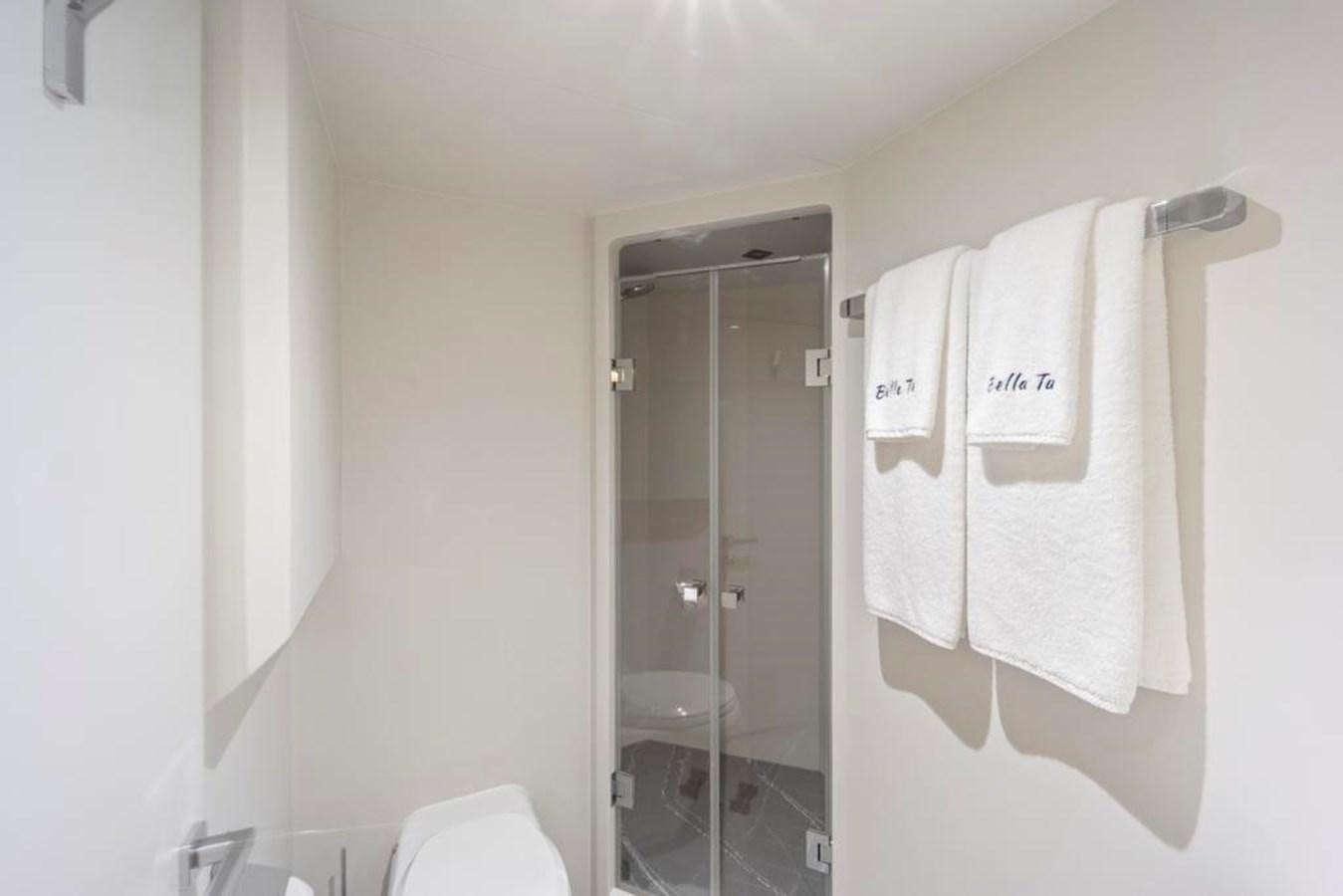 a bathroom with a glass shower aboard BELLA TU Yacht for Sale