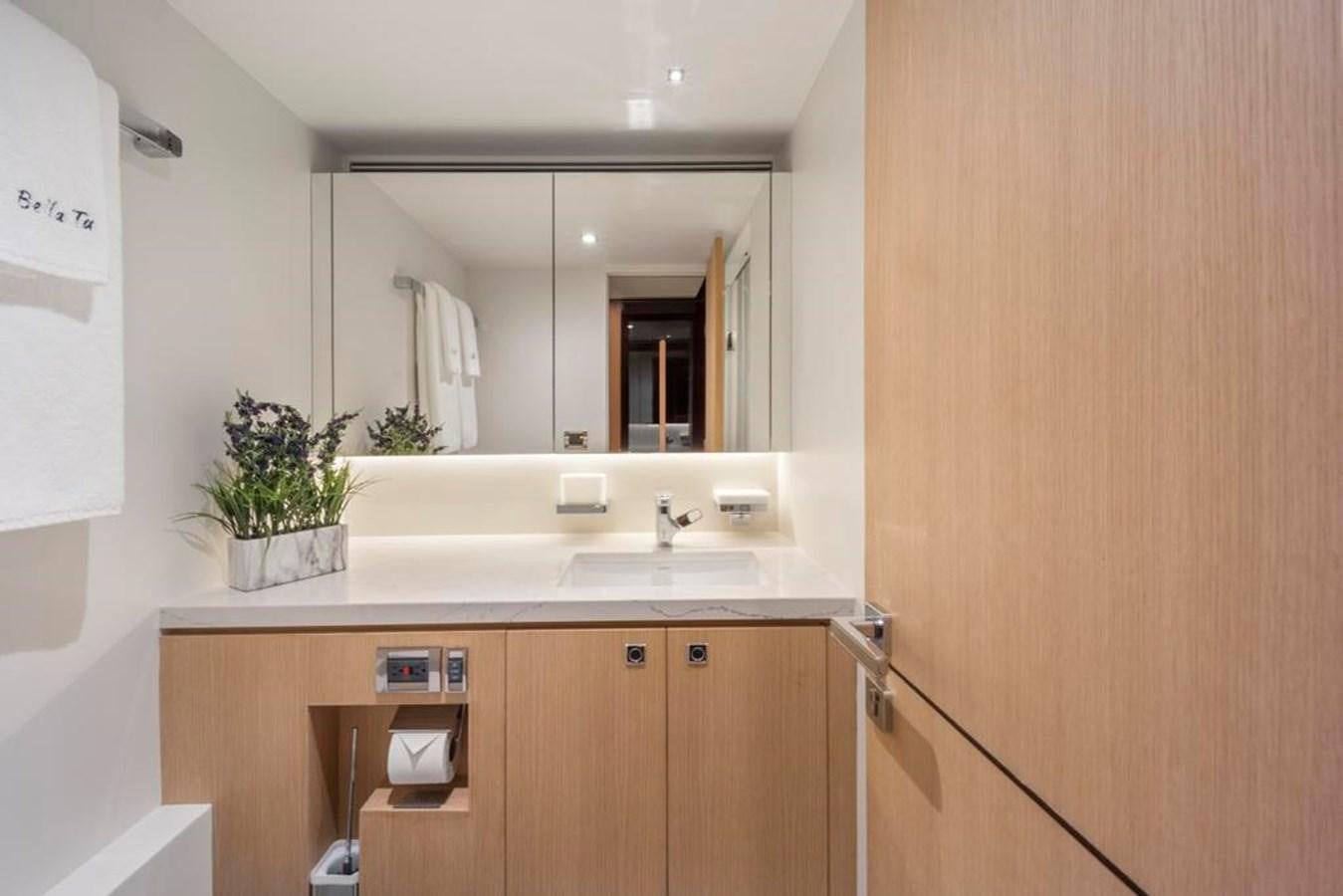 a bathroom with a large mirror aboard BELLA TU Yacht for Sale